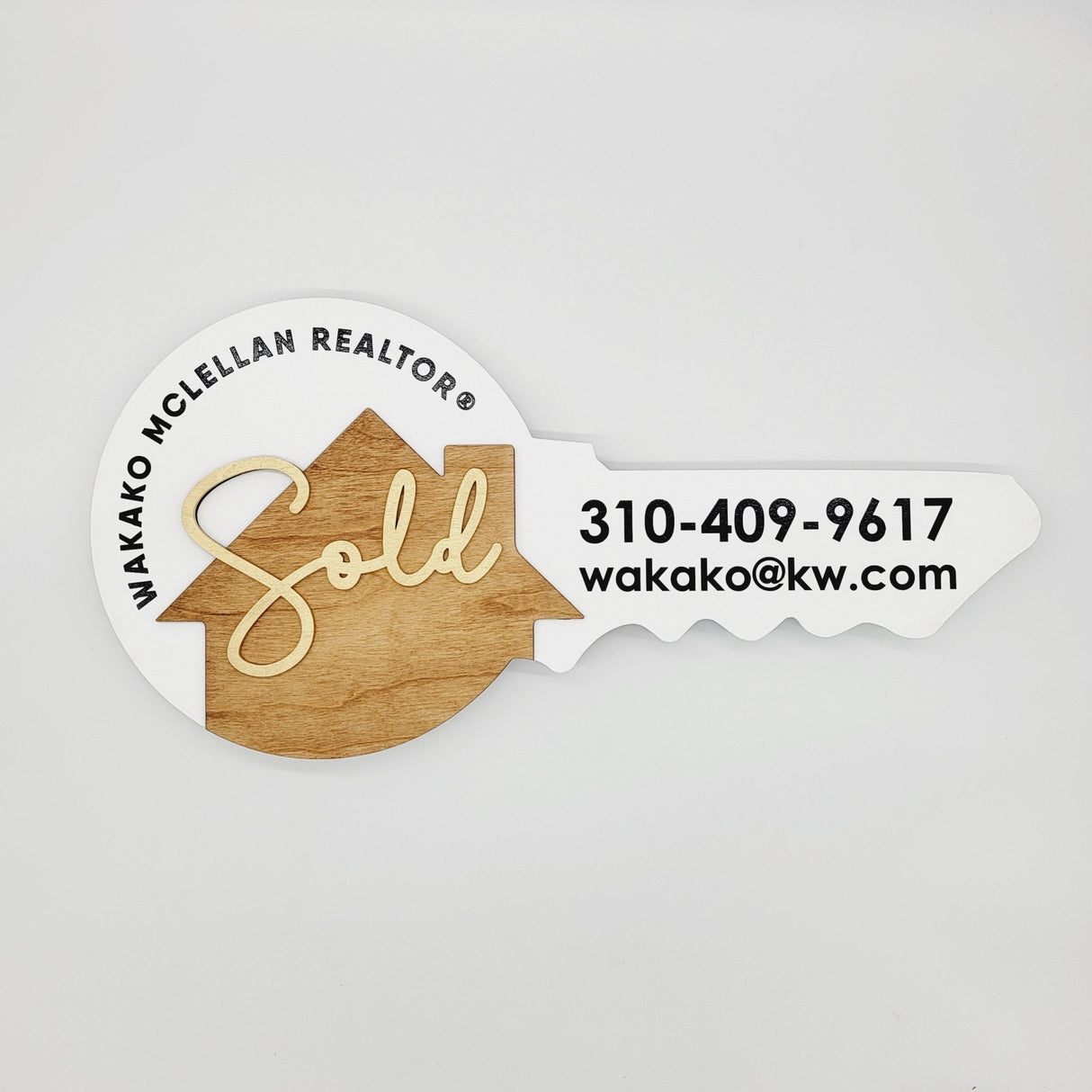 Round Shaped «Sold» Round Key Sign with a Wooden House - Real Estate Store