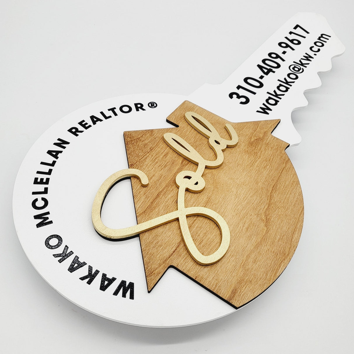 Round Shaped «Sold» Round Key Sign with a Wooden House - Real Estate Store