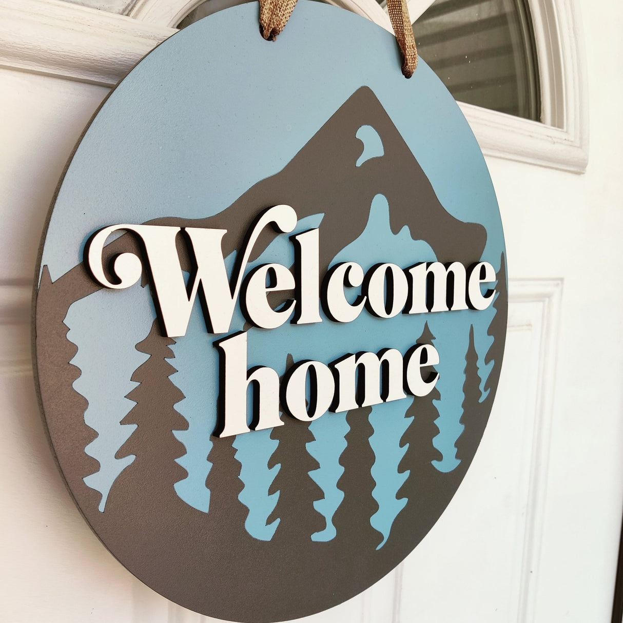 Wooden Front Door Hanger Sign «Welcome Home» with Mountains & Pines design - Real Estate Store