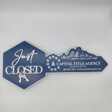 Just Closed Sign with a Cityscape