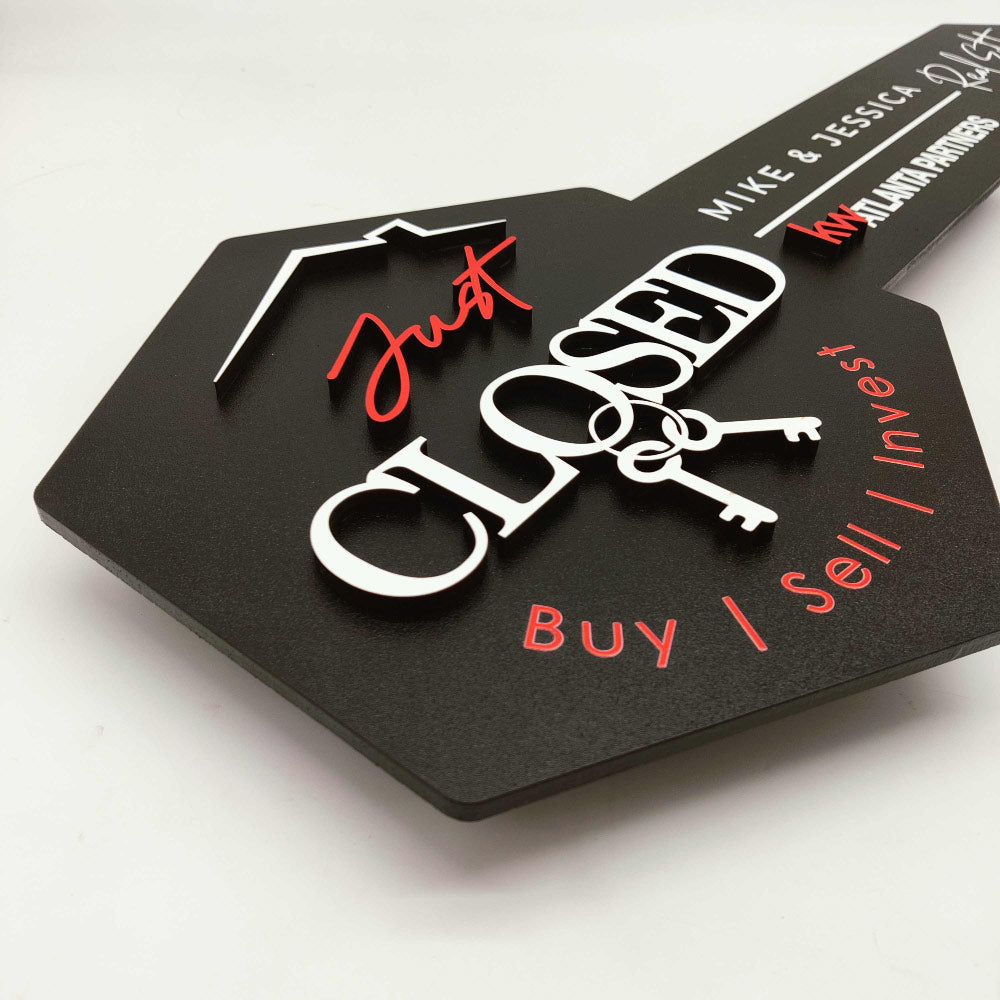 Black Key-Shaped Sign with "Just Closed " and hanging keys