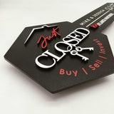 Black Key-Shaped Sign with "Just Closed " and hanging keys