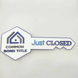 Key Shaped Sign White "Just Closed" with logo