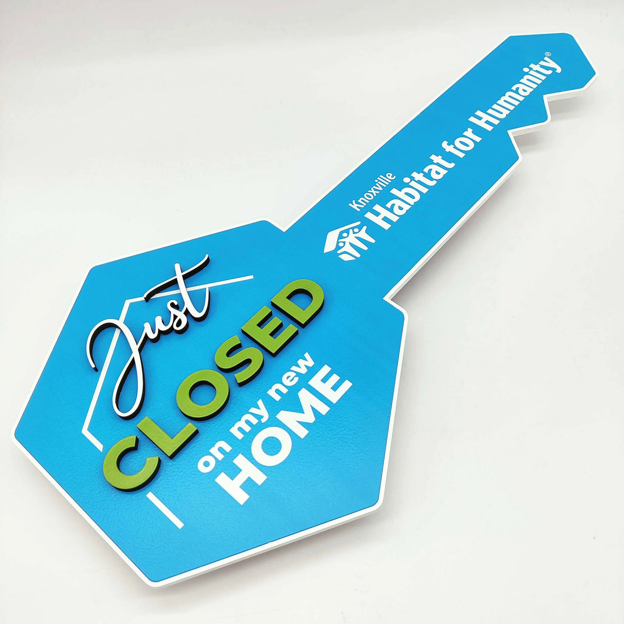 Key Shaped Sign Blue with With text & outline "Just Closed"