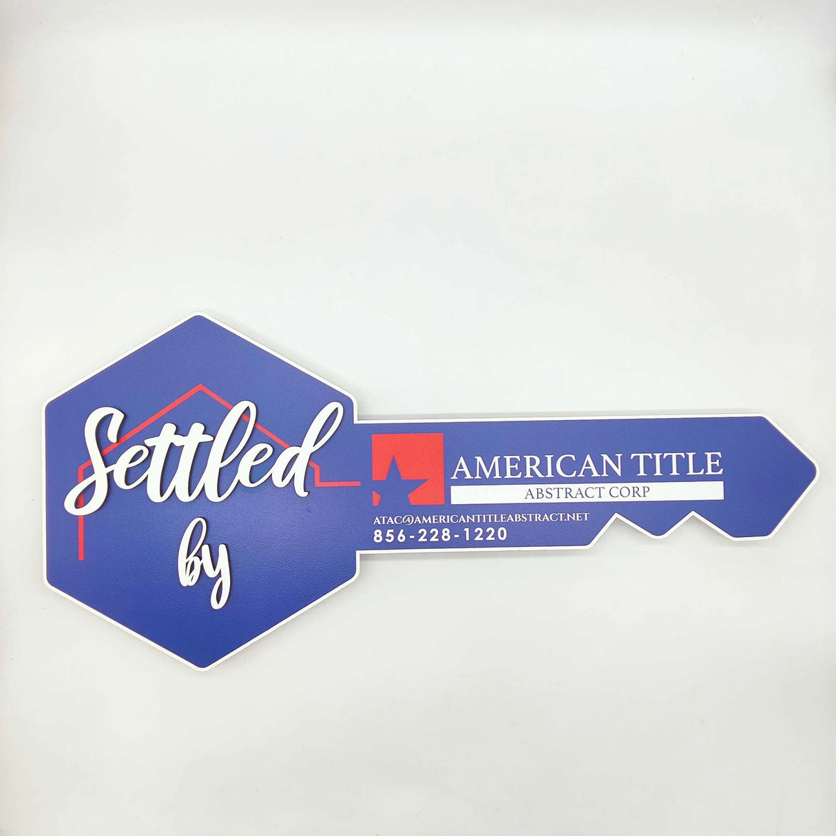 Key Shaped Sign Blue and white outline with 3D text "Settled by"