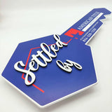 Key Shaped Sign Blue and white outline with 3D text "Settled by"