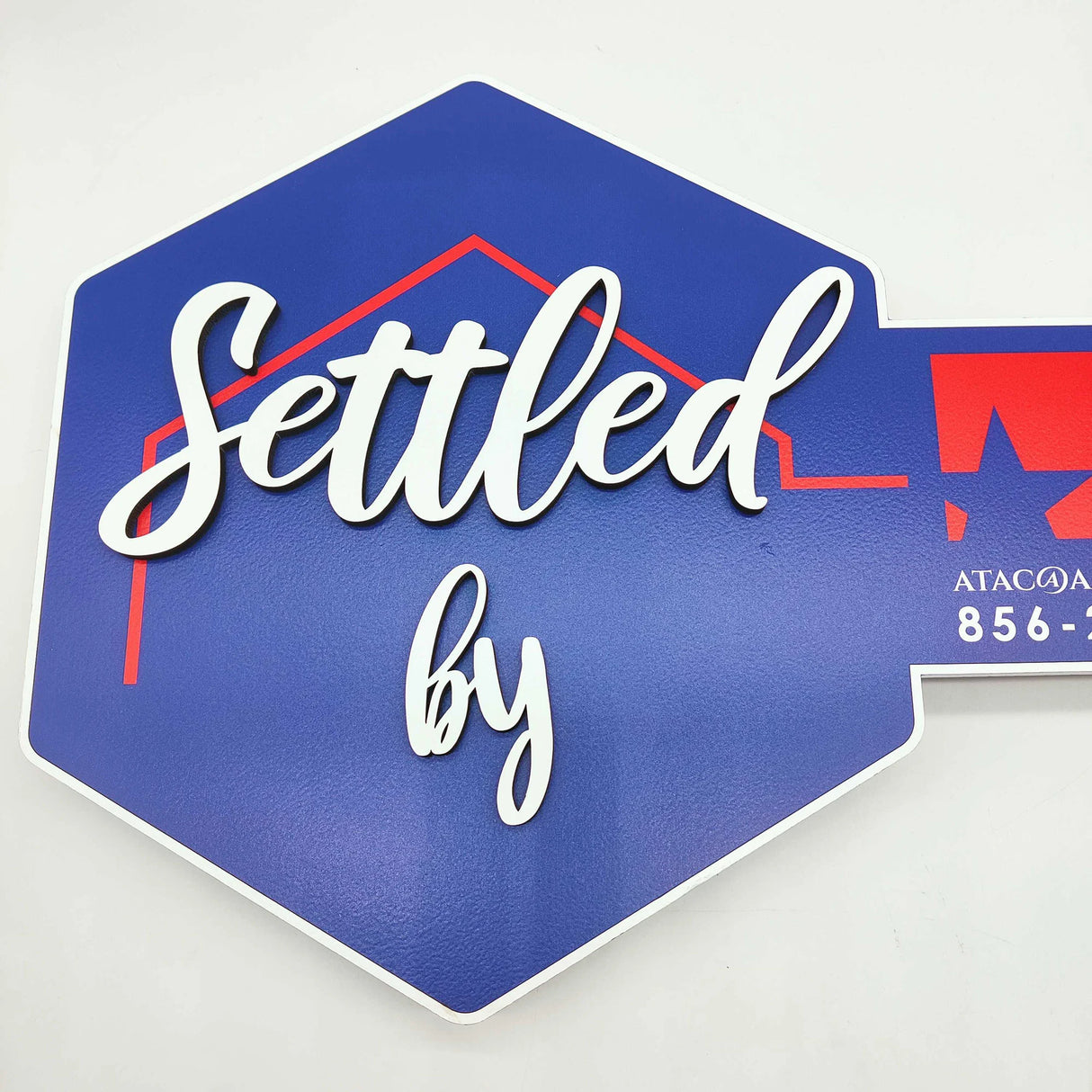 Key Shaped Sign Blue and white outline with 3D text "Settled by"