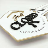 White Key-Shaped Sign "Closing deals in heels"