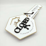 White Key-Shaped Sign "Closing deals in heels"